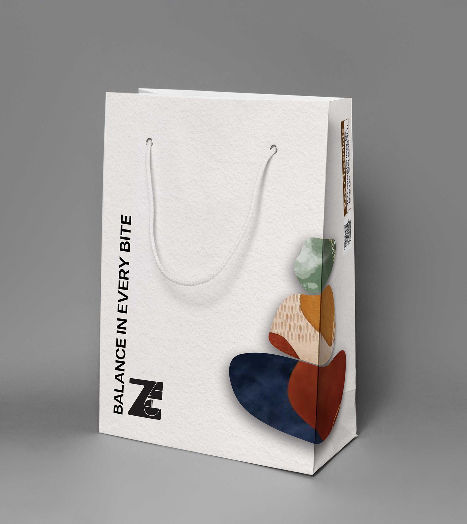 Angled view of the same branded shopping bag, showing side panel details and the abstract stacked-stone logo.
