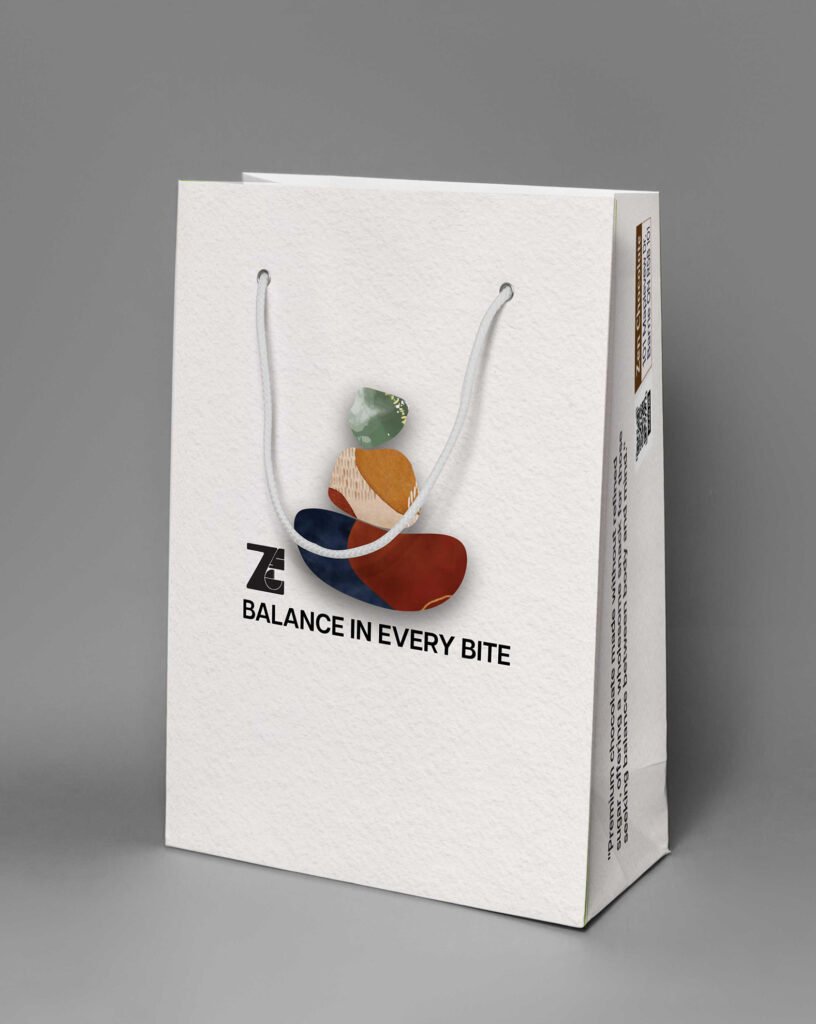 White paper shopping bag mockup with rope handles and “Balance in Every Bite” branding with an abstract stacked-stone graphic.